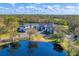 Stunning aerial shot of the home with a lake, showcasing the property's privacy and beautiful natural surroundings at 2410 Slough Rd, Sarasota, FL 34240