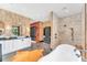 A bright bathroom featuring double sinks, modern fixtures, and a glass-enclosed shower at 2410 Slough Rd, Sarasota, FL 34240
