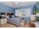 Serene bedroom with light blue walls, comfortable bed, and window shutters at 2467 E Del Webb Blvd, Sun City Center, FL 33573