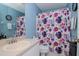 Clean bathroom with floral shower curtain and updated vanity at 2467 E Del Webb Blvd, Sun City Center, FL 33573