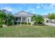 Well-maintained house with a lush front yard at 2467 E Del Webb Blvd, Sun City Center, FL 33573