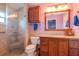 Updated bathroom with wood cabinets and a walk-in shower at 2467 E Del Webb Blvd, Sun City Center, FL 33573