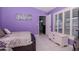 Purple bedroom with a comfortable bed and large window shutters at 2467 E Del Webb Blvd, Sun City Center, FL 33573
