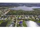 Expansive aerial view of neighborhood showcasing lake views and community layout; the property is marked by a blue pin at 2603 River Woods Dr, Parrish, FL 34219