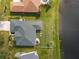 Aerial view of the home, showcasing the green roof, backyard, firepit, and its beautiful lakefront location at 2603 River Woods Dr, Parrish, FL 34219