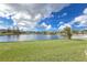 Expansive backyard with a lush lawn and a picturesque view of the lake, perfect for outdoor activities and relaxation at 2603 River Woods Dr, Parrish, FL 34219