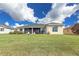 Expansive backyard featuring a screened lanai and a green lawn, perfect for outdoor activities and relaxation at 2603 River Woods Dr, Parrish, FL 34219