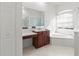 Bright bathroom with a vanity, ample counter space, a bathtub, and a window at 2603 River Woods Dr, Parrish, FL 34219