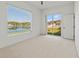 Bright and airy bedroom with a lakeside view, plush carpet and a patio access at 2603 River Woods Dr, Parrish, FL 34219