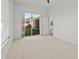 Bright bedroom features neutral carpet, large sliding glass door with backyard views, and easy access to outdoors at 2603 River Woods Dr, Parrish, FL 34219