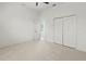 Light bedroom with closet, neutral carpet, and bright light from the door opening to the blue skies at 2603 River Woods Dr, Parrish, FL 34219