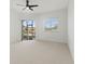 Bedroom featuring neutral carpet, ceiling fan, and sliding glass doors leading to an outdoor patio at 2603 River Woods Dr, Parrish, FL 34219