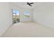 A spacious, naturally lit bedroom with neutral carpet and sliding glass door at 2603 River Woods Dr, Parrish, FL 34219
