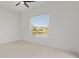 This bedroom features a ceiling fan and a large window overlooking a lake at 2603 River Woods Dr, Parrish, FL 34219