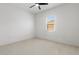Well-lit bedroom with plush carpet and a single window at 2603 River Woods Dr, Parrish, FL 34219