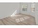 Cozy bedroom with natural light streaming through the windows and modern wood-look floors at 2603 River Woods Dr, Parrish, FL 34219