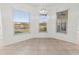 Bright breakfast nook featuring tile flooring and picturesque lake views from three large windows at 2603 River Woods Dr, Parrish, FL 34219