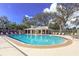 Community pool with lounge chairs and a covered pavilion, perfect for relaxation and socializing at 2603 River Woods Dr, Parrish, FL 34219