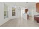 Bright dining area showcasing elegant tile floors, modern light fixture, and open access to kitchen at 2603 River Woods Dr, Parrish, FL 34219