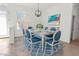 Bright dining room with white wood table and blue upholstered chairs plus modern light fixture at 2603 River Woods Dr, Parrish, FL 34219