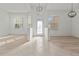 Inviting foyer with decorative front door, high ceilings and stylish light fixtures at 2603 River Woods Dr, Parrish, FL 34219