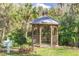 Cozy gazebo nestled amongst mature trees in a private area of the property ideal for relaxation and gatherings at 2603 River Woods Dr, Parrish, FL 34219