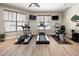 Community gym with modern exercise equipment and ample natural light from large windows, providing a great workout space at 2603 River Woods Dr, Parrish, FL 34219