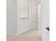A clean hallway with neutral carpet and white trim, offering a sense of spaciousness at 2603 River Woods Dr, Parrish, FL 34219
