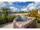 Relaxing hot tub with a view of the lake surrounded by lush landscaping and a manicured backyard at 2603 River Woods Dr, Parrish, FL 34219