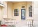 Front porch with stone detailing and a blue door at 2603 River Woods Dr, Parrish, FL 34219