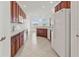 Bright, open kitchen with wood cabinets, white appliances, and tile flooring at 2603 River Woods Dr, Parrish, FL 34219