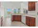 Charming kitchen featuring tile flooring, modern appliances, and scenic views of the lake from the window at 2603 River Woods Dr, Parrish, FL 34219