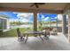 Covered lanai featuring a dining table and chairs, offering serene water views and a relaxing outdoor space at 2603 River Woods Dr, Parrish, FL 34219