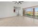 Open concept living room with tile flooring, ceiling fan, and access to the kitchen and screened-in porch at 2603 River Woods Dr, Parrish, FL 34219