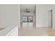 Open-concept living area with tile flooring and views of the lake through sliding glass doors at 2603 River Woods Dr, Parrish, FL 34219