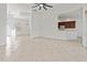 Spacious open-concept living room with tile flooring, access to the kitchen, and stylish light fixtures at 2603 River Woods Dr, Parrish, FL 34219