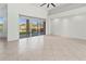 Bright living room with sliding glass doors leading to a screened patio and lake view at 2603 River Woods Dr, Parrish, FL 34219