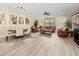 Bright living room with wood floors, ceiling fan, and comfortable leather seating in a shared community space at 2603 River Woods Dr, Parrish, FL 34219