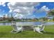 Relaxing lake view from the backyard with fire pit at 2603 River Woods Dr, Parrish, FL 34219