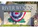 Community sign for River Woods with patriotic bunting at 2603 River Woods Dr, Parrish, FL 34219