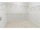 Spacious walk-in closet with metal shelving and neutral carpet at 2603 River Woods Dr, Parrish, FL 34219