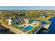 Aerial view of the community clubhouse, pool and tennis court overlooking a pond at 341 108Th W St # 242, Bradenton, FL 34209