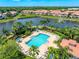 Aerial view of community pool and lake at 3601 Parkridge Cir # 12-104, Sarasota, FL 34243