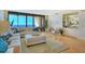 Spacious living room with ocean view, featuring comfortable seating and hardwood floors at 415 L Ambiance Dr # C703, Longboat Key, FL 34228