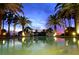 Inviting pool area with palm trees and sunset views at 415 L Ambiance Dr # C703, Longboat Key, FL 34228