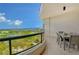 Spacious balcony with outdoor furniture and stunning water views at 415 L Ambiance Dr # C703, Longboat Key, FL 34228