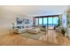 Spacious living room with hardwood floors and ocean views at 415 L Ambiance Dr # C703, Longboat Key, FL 34228