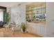 Wet bar with mirrored shelving and cabinetry at 415 L Ambiance Dr # C703, Longboat Key, FL 34228