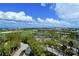Aerial view showcasing lush landscaping and a golf course at 415 L Ambiance Dr # C703, Longboat Key, FL 34228