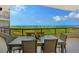 Private balcony with scenic ocean views and outdoor dining at 415 L Ambiance Dr # C703, Longboat Key, FL 34228